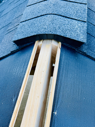 A lifted ridge vent leaving an open gap into the attic